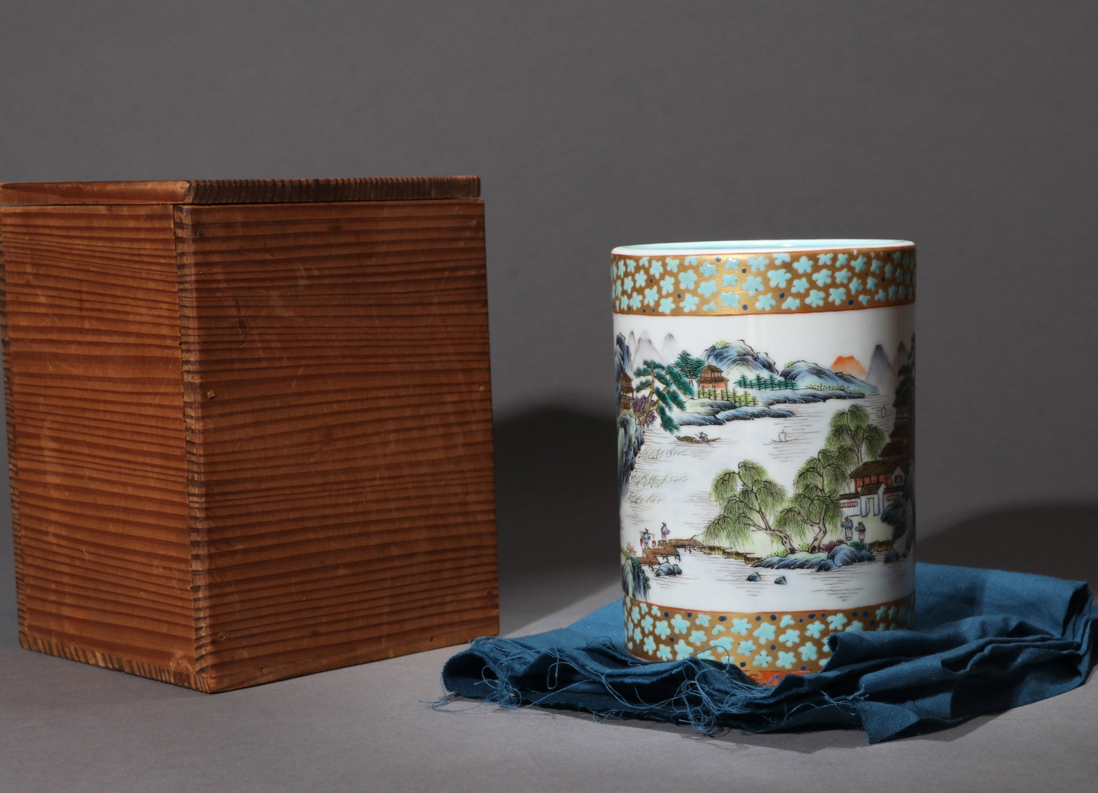 A FAMILLE-ROSE 'LANDSCAPE' BRUSH POT WITH POEM INSCRIPTION: A famille-rose brush pot decorated with landscape panels and a poem inscription. Diameter 9.5 cm, height 13.5 cm.