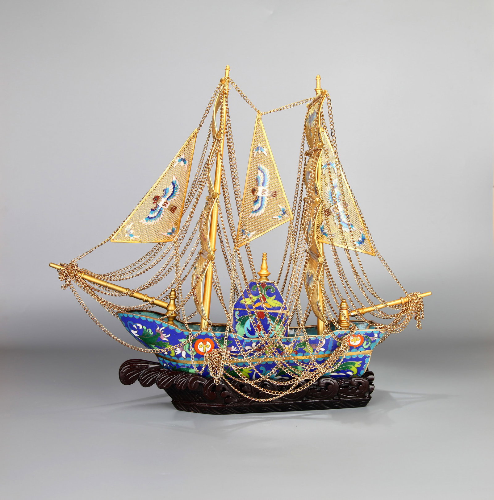 A CLOISONNE AND FILIGREE MODEL OF A SHIP: A cloisonne and filigree model of a ship. Length 32 cm, height 40 cm.