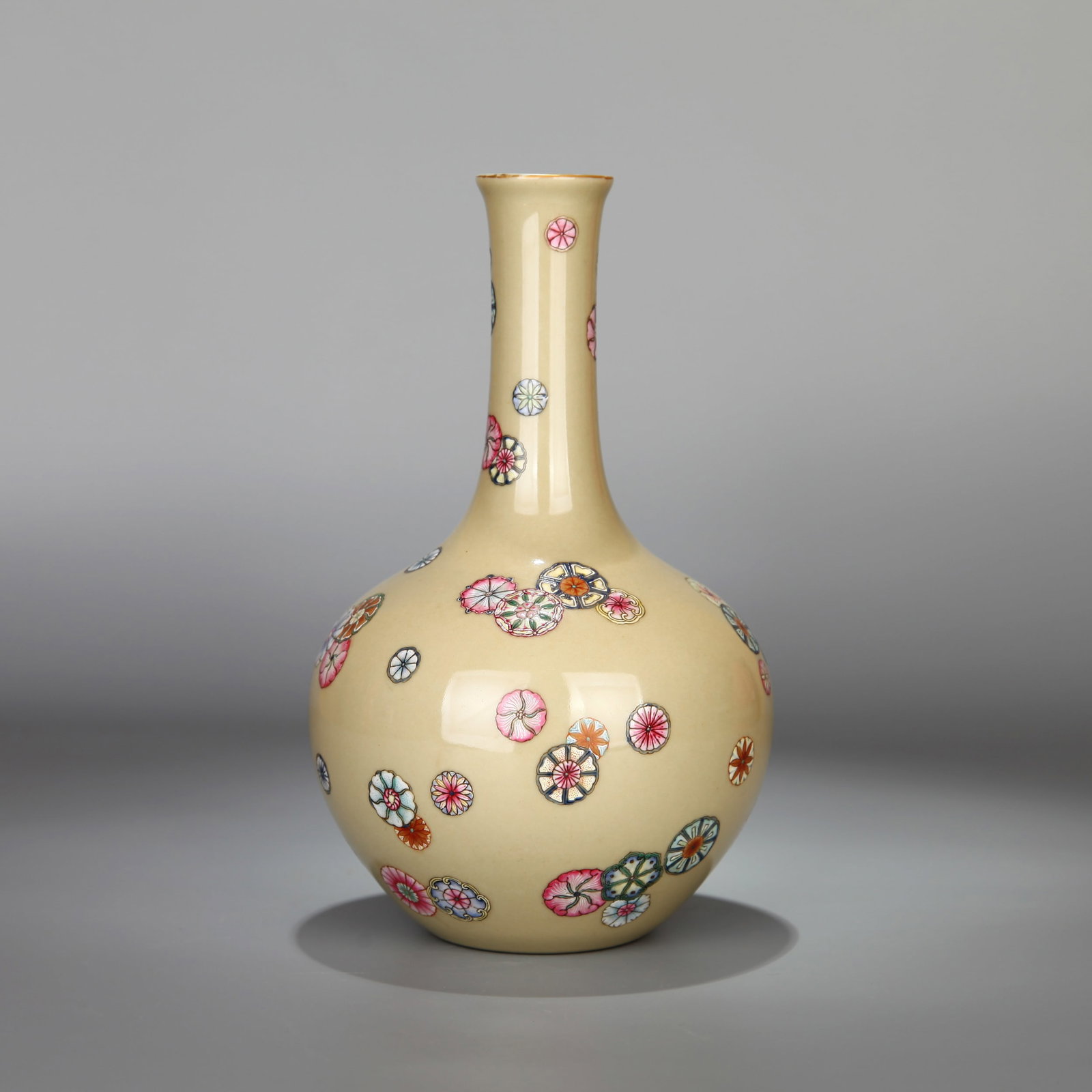 A BEIGE-GLAZED FAMILLE-ROSE 'FLOWER-BALL' SMALL TIANQIU VASE: A small beige-glazed famille-rose tianqiu vase decorated with flower-ball motifs. Ht. 21.5 cm.
