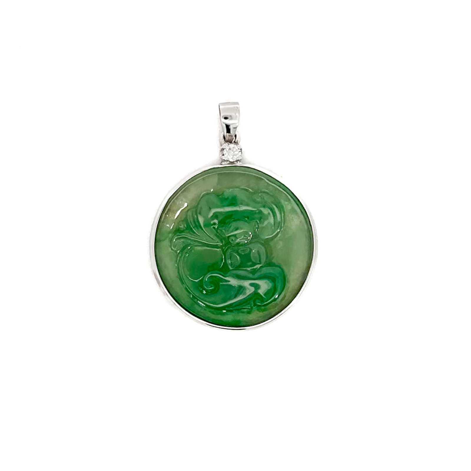 NATURAL JADEITE PENDANT SET IN WHITE GOLD: Natural jadeite pendant carved with a bat and ruyi, symbolizing longevity, set in white gold. 0.98"d (2.5 cm)