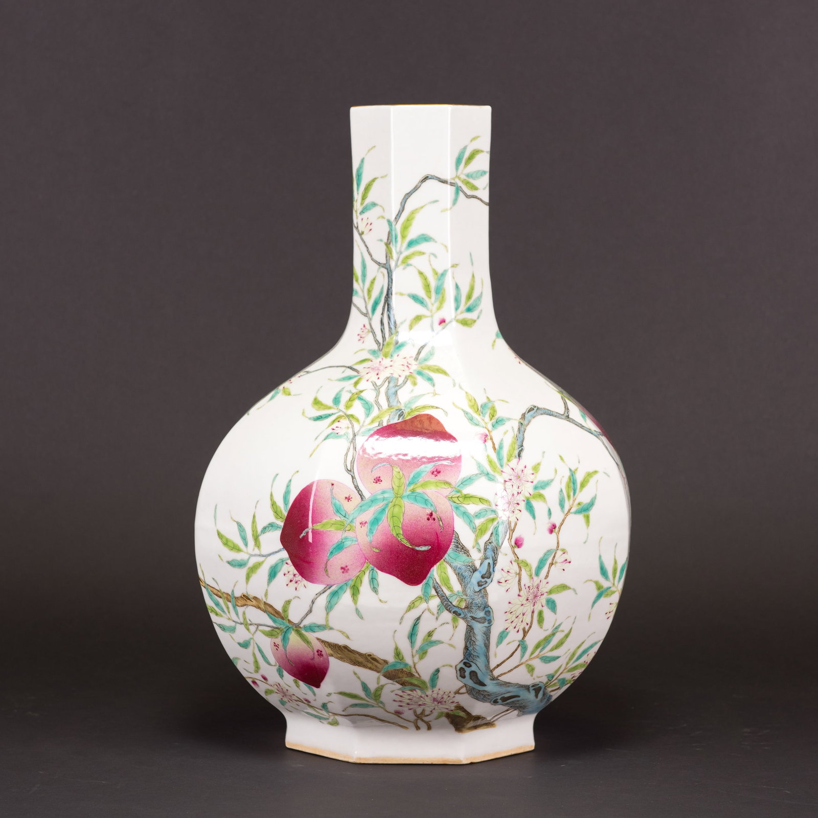 CHINESE FAMILLE-ROSE 'PEACH' BOTTLE VASE: A large Chinese famille-rose 'peach' bottle vase decorated with fruiting peach tree branches. A six-character 'Da Qing Qian Long Nian Zhi' seal mark is on the base. 17.32"h x 12.2"w (44 x 31 cm)