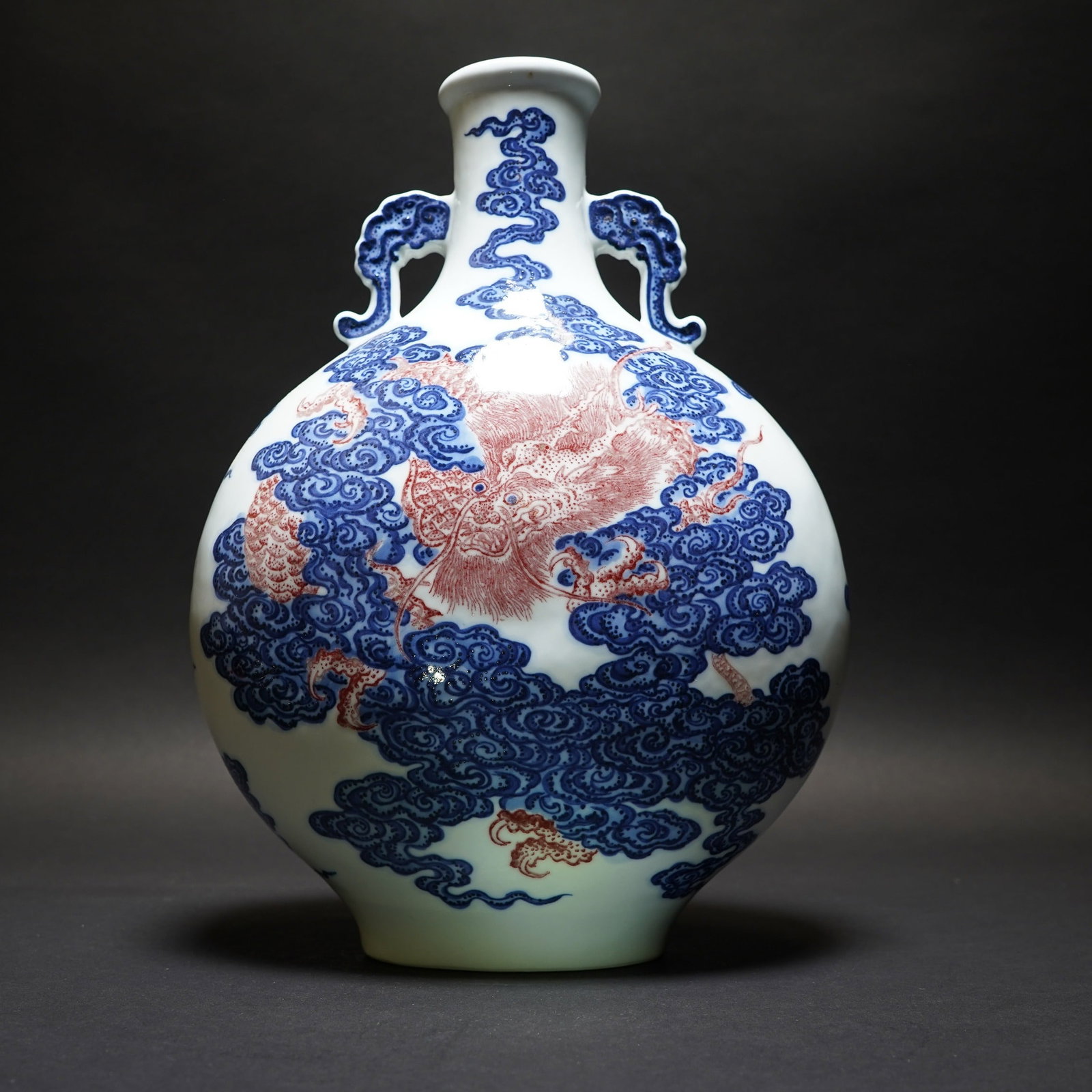 A BLUE-AND-WHITE AND COPPER-RED 'DRAGON' MOONFLASK, QIANLONG MARK: A blue-and-white and copper-red 'dragon' moonflask, Qianlong mark. 12.6"h x 9.06"d (32 x 23 cm)