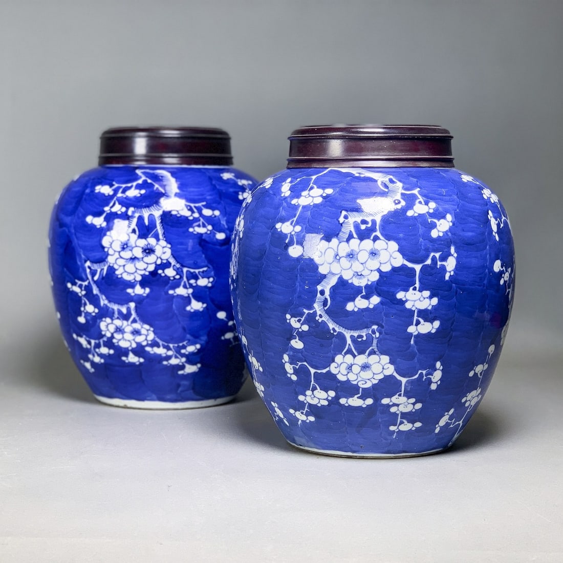 (LOT OF 2) PAIR OF BLUE-AND-WHITE 'PRUNUS' OVOID JARS, 19TH CENTURY: (lot of 2) A pair of blue-and-white 'prunus' ovoid jars, each decorated with blossoming plum branches against a cracked-ice ground. H26 x 11.5 cm (x2)