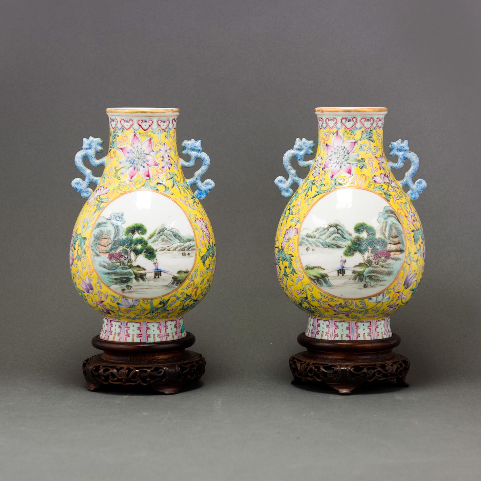 (LOT OF 2) PAIR OF FAMILLE-ROSE YELLOW-GROUND 'LANDSCAPE' VASES, REPUBLIC PERIOD: (lot of 2) A pair of famille-rose yellow-ground 'landscape' vases, Republic period, each decorated in mirror image with two roundels enclosing a mountain scene, all reserved on a yellow ground with