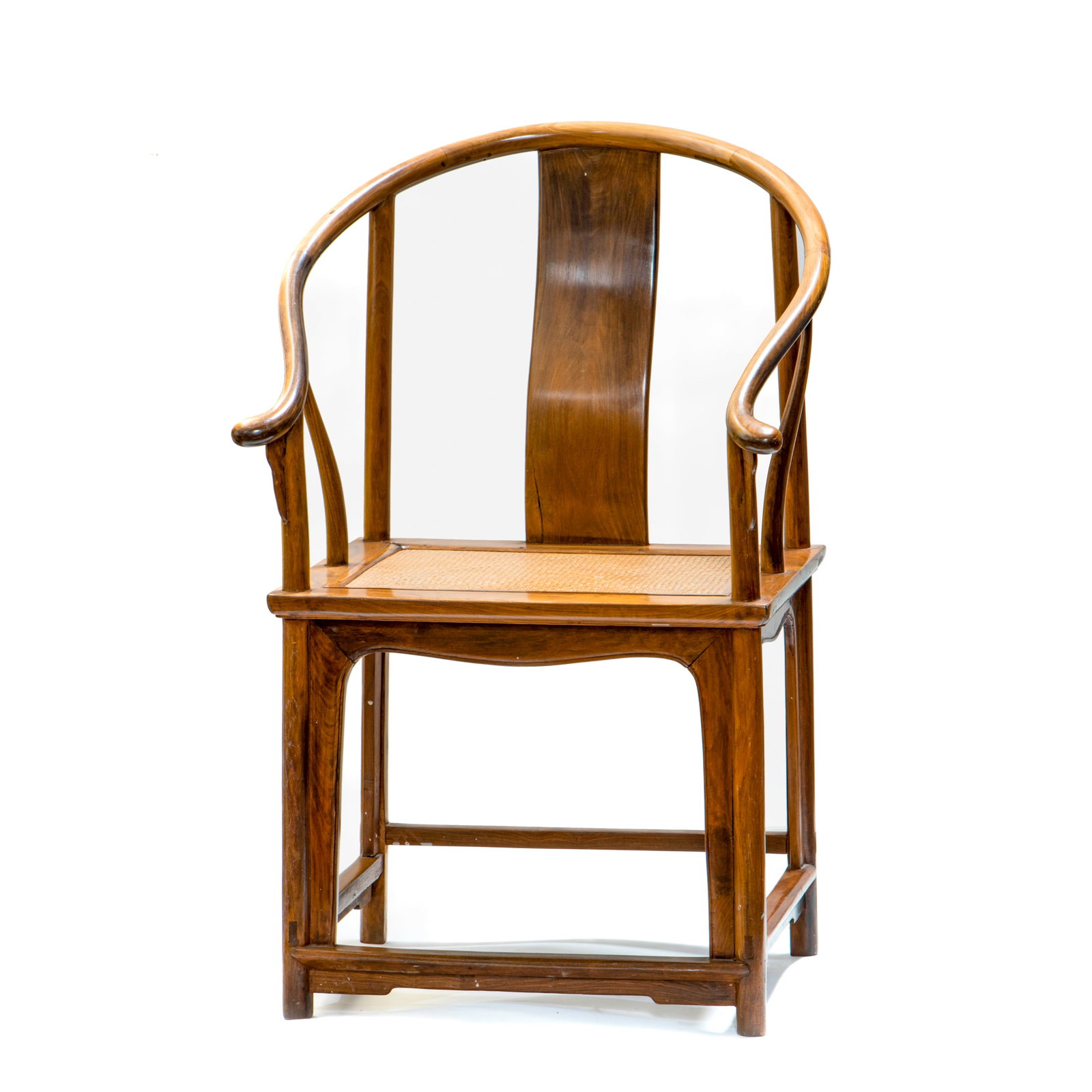 A HUANGHUALI CONTINUOUS HORSESHOE-BACK ARMCHAIR (Y): A huanghuali continuous horseshoe-back armchair. The crest rail forms a continuous, elegant curve above the supporting S-shaped splat and back stiles before curving downwards in a sinuous line to