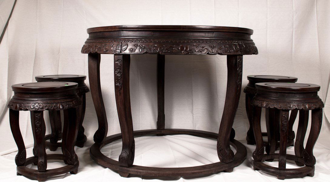 Large Carved Rosewood Round Tea Table with Four Stools: A large intricately carved rosewood round table (possibly Zitan) with a band of beautifully carved longevity bats and clouds decoration details surrounding the side of the table and chairs. Diameter 4