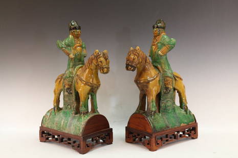 A Pair of Chinese Sancai Glazed Pottery: A Pair of Chinese Sancai Glazed Pottery depicting a warrior riding the horse with both hands by the waist. Width 5.25" Depth 8.75" Height 16.5" (with stand)