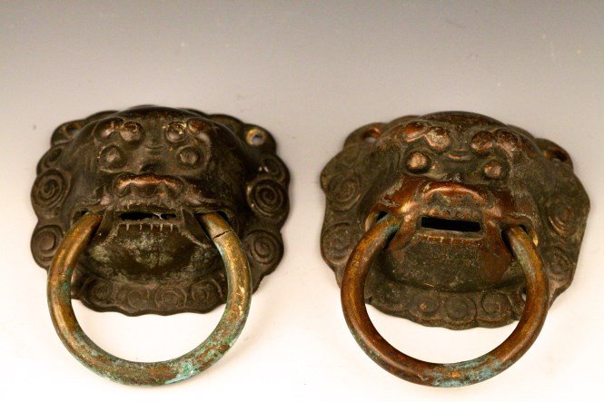 A Pair of Chinese Bronze Door Handle: A pair of Chinese bronze door handle in the shape of Chinese lion head. Width 4.5"