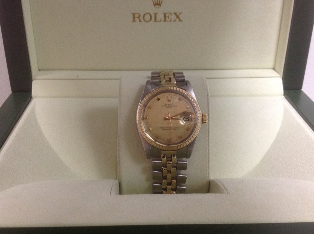 Men's Rolex Two Tone 14k yellow gold & stainless steel: Men's Rolex Two Tone 14k yellow gold and stainless steel Rolex brushed oyster perpetual date champagne dial gilt wedge indices dial hour markers 34mm case size bezel Rolex engine turned bezel 14k yell