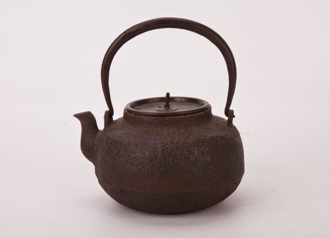 Japanese Cast Iron Teapot: Japanese Cast Iron Teapot, featuring corrugated siding with an oversized loop handle. Diameter 5.75" Height 4.25"