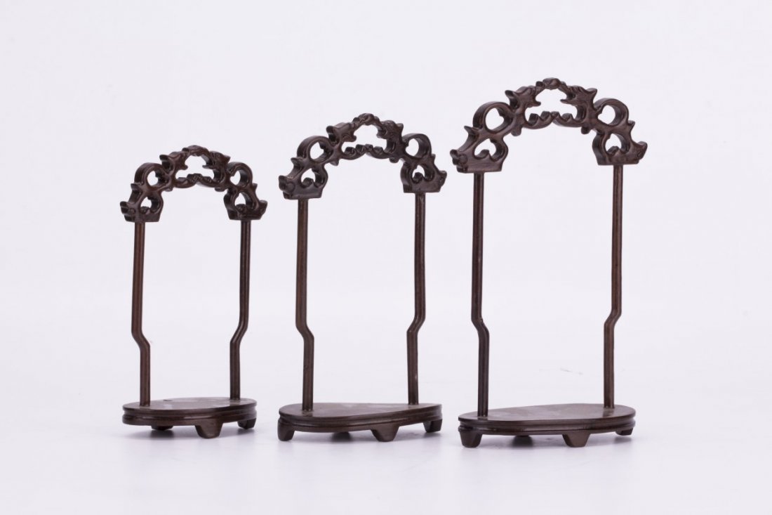 A Group of Three Chinese Rosewood Display Stands: A Group of Three Chinese Rosewood Display Stands, each of cloud-like frame with exquisite carving details. Width 4: Height 7.25" (Tallest)