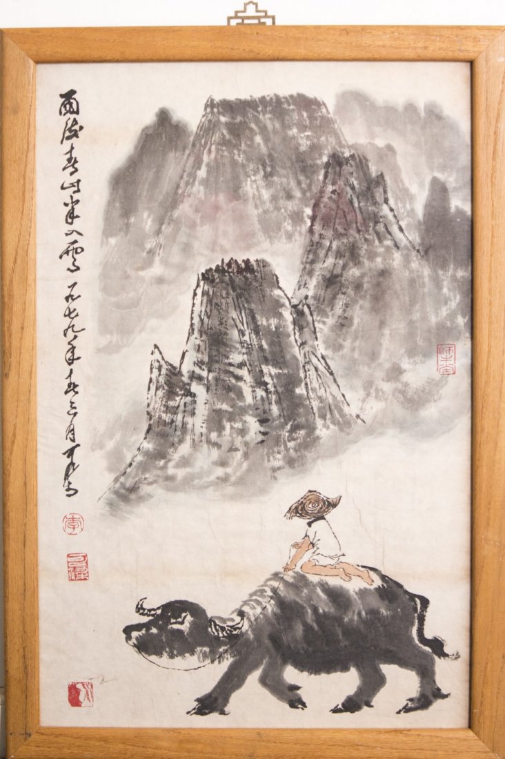 Chinese Framed Painting: Chinese ink and color on paper framed painting, depicting a child riding on a buffalo with mountainous landscape scenery in the background, attribute to Li Keran with a red seal mark. Length 27.75" Wi