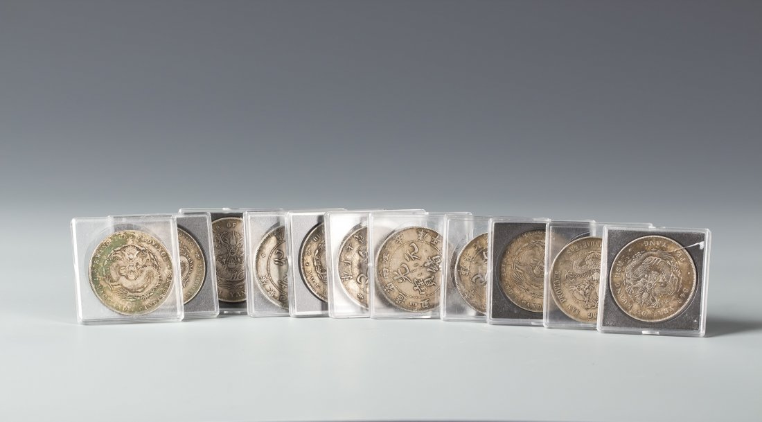 A group of Chinese Guang Xu silver coins: A group of eleven pieces Chinese Guangxu Sliver Coins, with the value of 7 Mace and 2 Candareens, design with four inscription words "????" on the front side and dragon on the back side. Its include 4