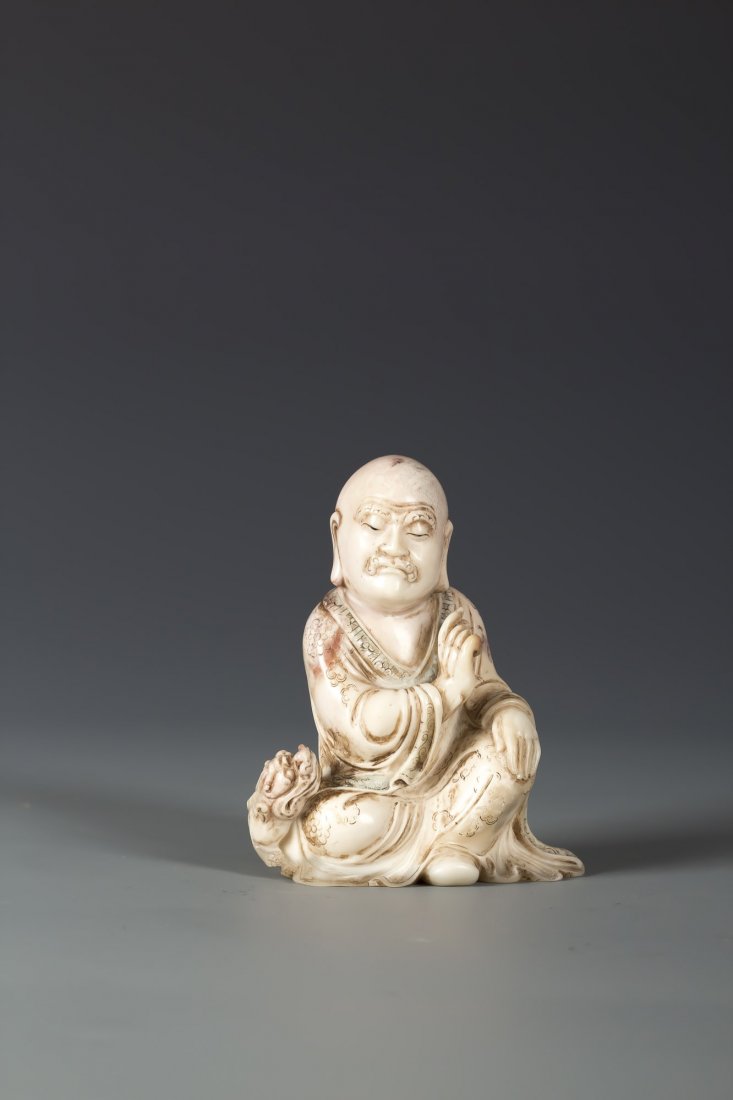 Chinese Soapstone Shoushan Sculpture: Chinese Soapstone Shoushan Sculpture, realistically carved of a Luo Han on a seated position with a beast on his side. Width 3.25” Height 4.25”