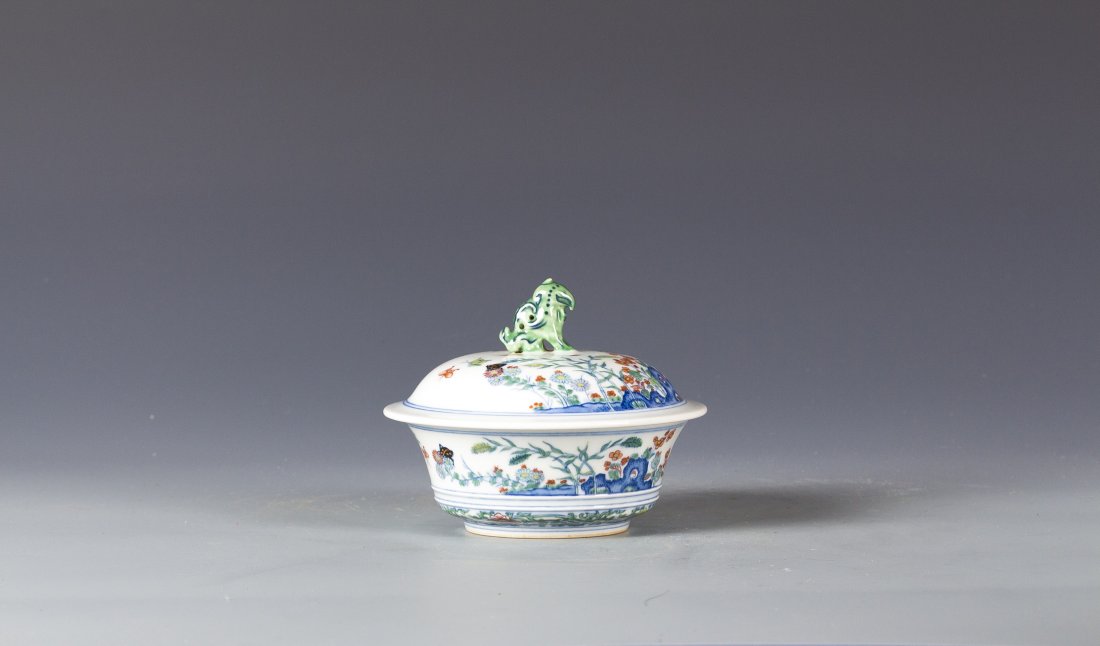Chinese Doucai Porcelain Bowl with lid: Chinese Doucai Porcelain Bowl with lid standing of a foo lion sculpture, finely painted around the body sprays of flowers and leaves on rock, repeated within the bottom rim a continuous foliate scroll