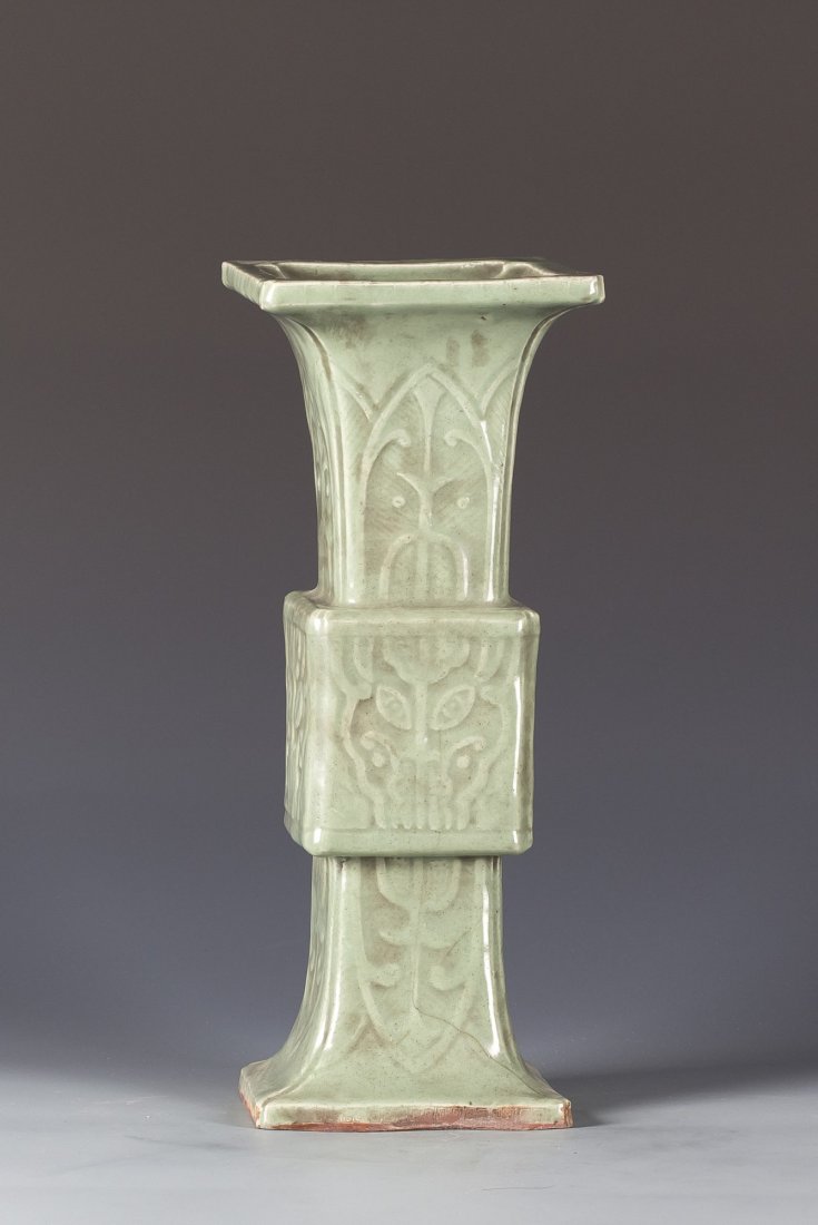 Celadon Archaistic Vase: Celadon Archaistic Vase of square form with carved leaf form patterns on all the sides. Height 16" Length 6" Width 6"