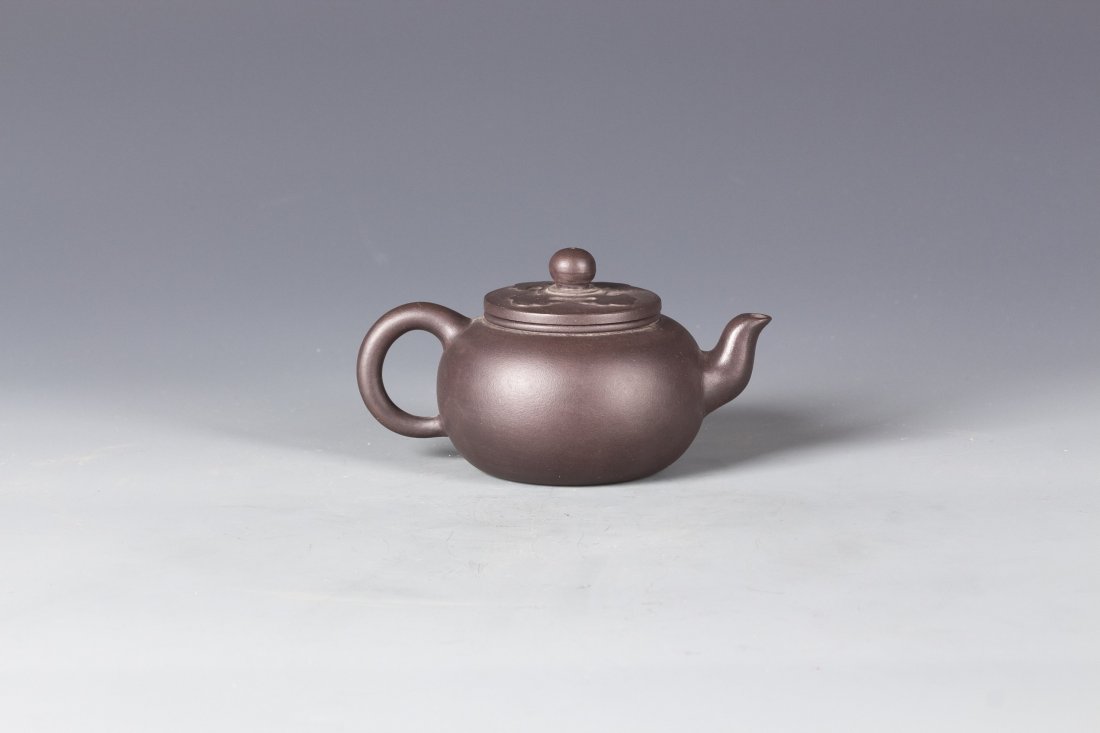 Chinese Zisha Clay Teapot: Chinese Zisha Clay Teapot, the lid is carved with fiery cloud in raised relief pattern, comes with seal at the bottom of the Teapot. Diameter 4" Height 3.25"