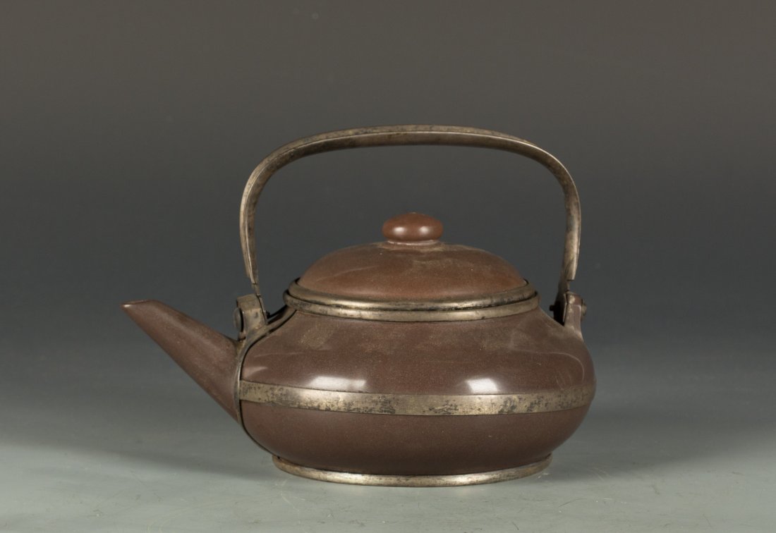 Zisha Teapot Mark with Gong Ju: Chinese Round shape Zisha clay Teapot with copper handle. The body, edge, bottom and lid are covered by copper. Mark with Gong Ju. Length 8" Width 6.25" Height 5.5"