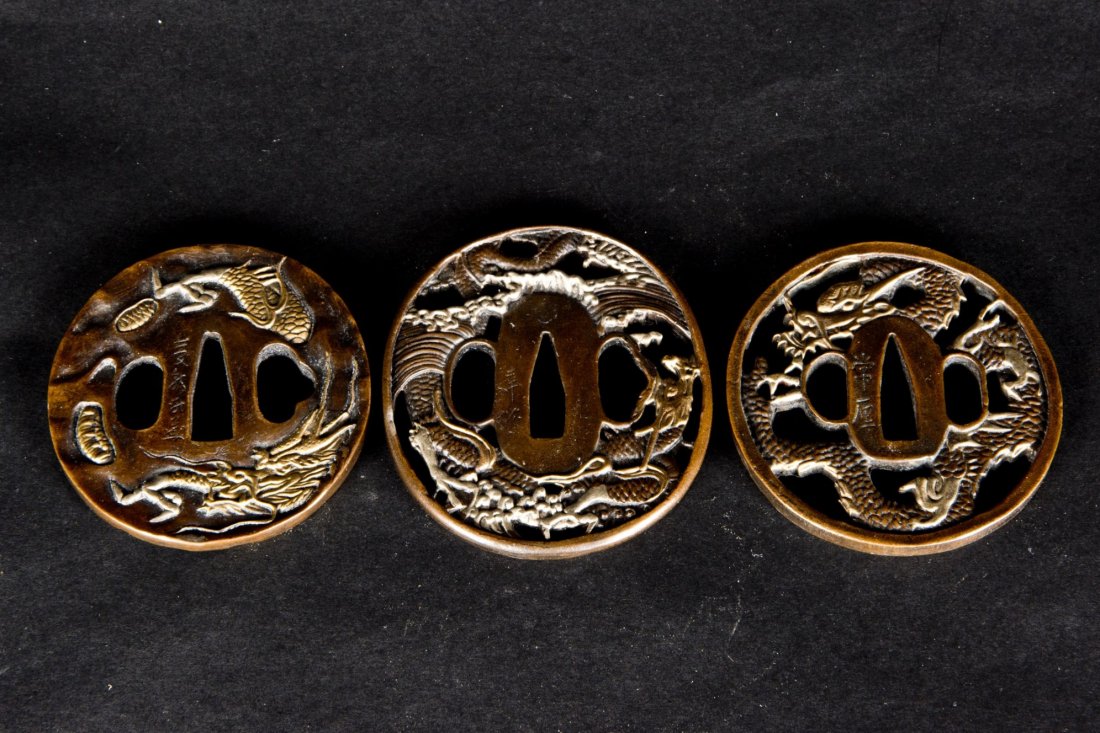 A Set of Bronze Sword Parrying: Three Bronze Sword Parryings, inlaid Silver and Gold, vivid relief of Tiger, Dragon, Waves Patterns and Chinese Characters. Diameter approx. 3''