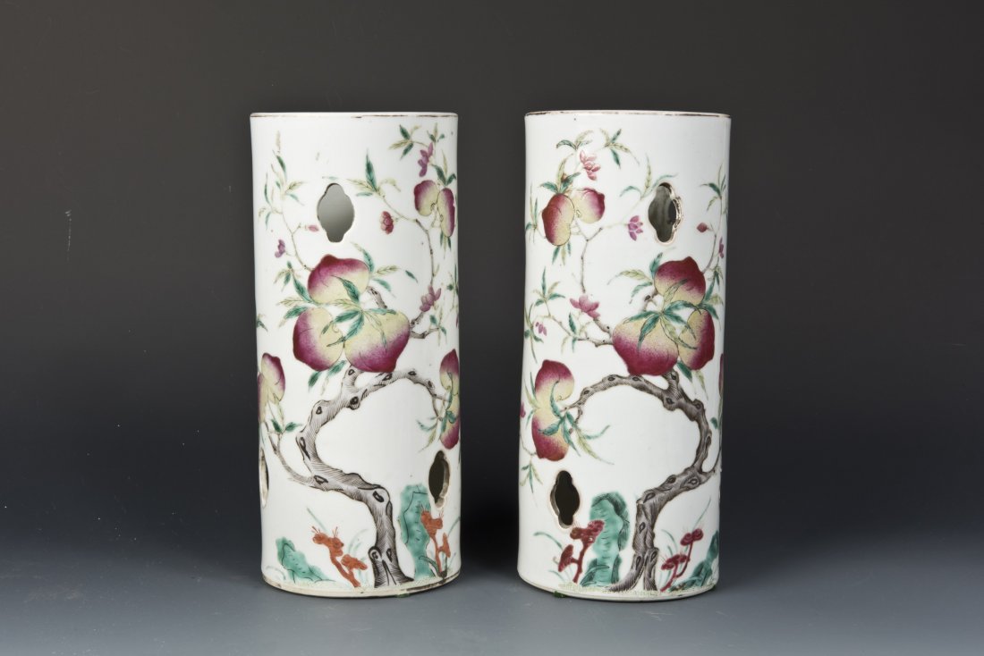 Pair of Famille Rose Porcelain Incense Containers: Pair of Famille Rose Porcelain Incense Containers of cylinder form, symmetric patterns themed peaches and bats, with decorative holes. Red Bottom Seal on each. Height 11.25'' Diameter 4.875''