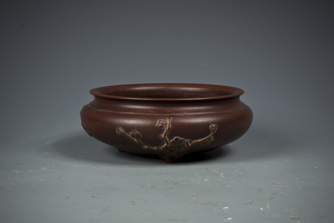 Tri-Foot Zisha Brush Washer: A Tri-Foot Zisha Brush Washer with relief of daisy, bamboo, and plum blossom on the exterior, Bottom Sealed and with minor damage. Diameter 6.5'' Height 2.5''