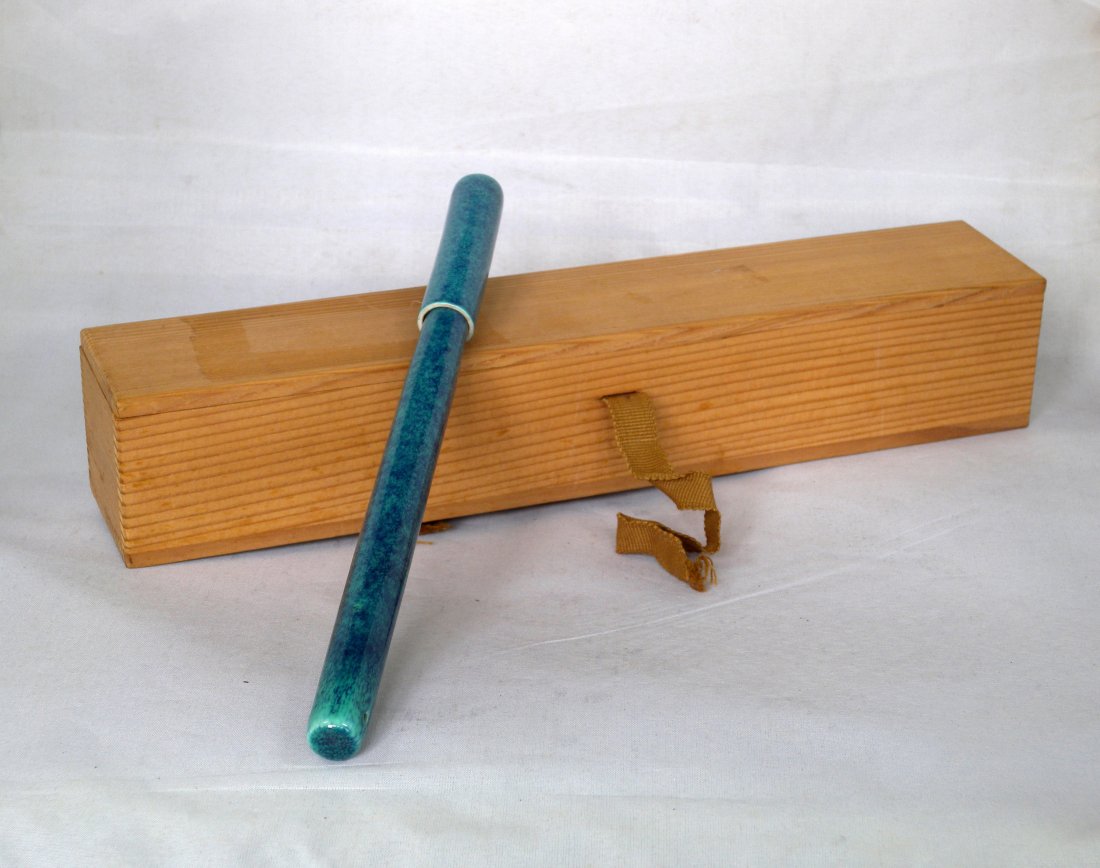 A FURNACE-GLAZED PORCELAIN BRUSH: A Chinese brush pen coated with furnace-glazed (Lu Jun You) porcelain, includes a wooden box, bearing a vertical six-character seal . 9.25"