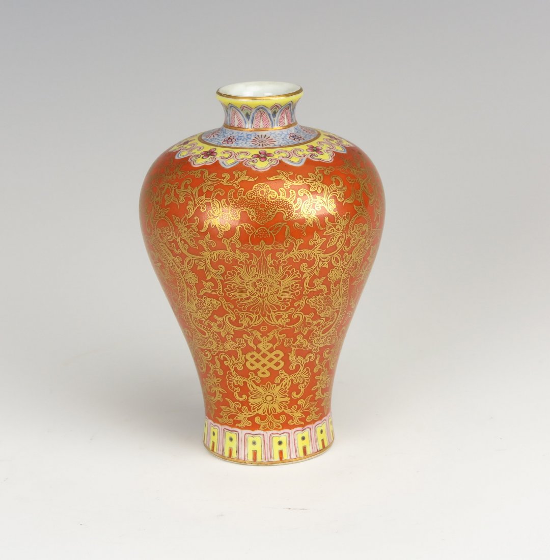 Chinese Porcelain Vase: A chinese porcelain vase, of baluster shape with a short neck. It is decorated with auspicious dragons and scrolling lotus foliage with coral red background color. A six character mark is imprinted on