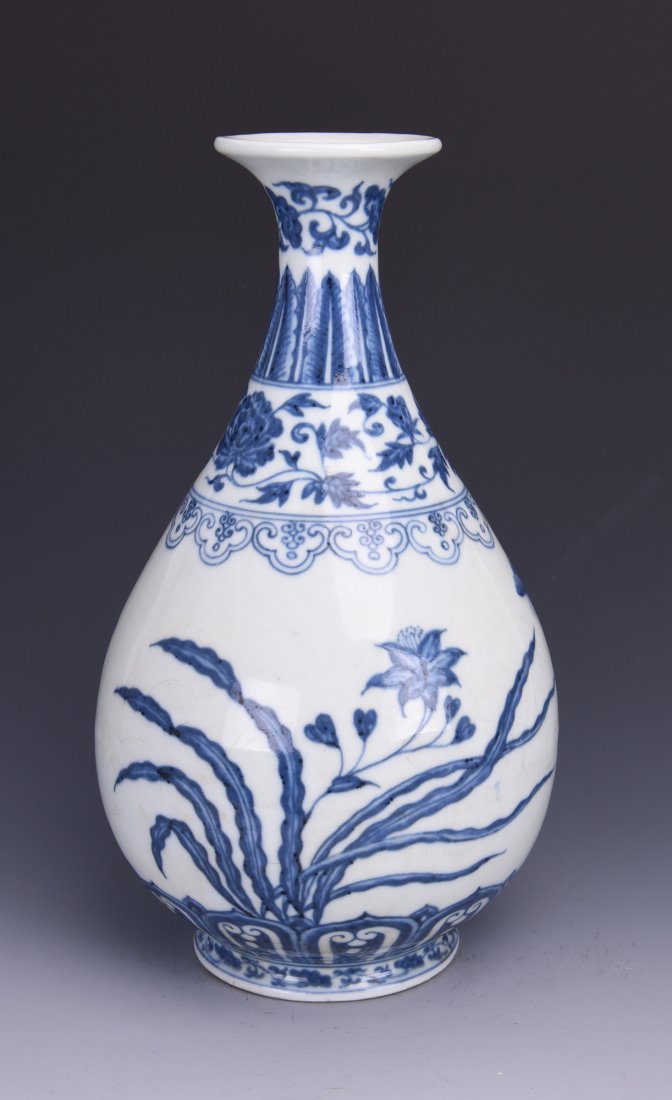 A BLUE AND WHITE YU HU CHUN PORCELAIN VASE: The classic Chinese Yu Hu Chun porcelain vase is stylized by blue and white paintings of orchid below ruyi lappets and flower and foliage bands by the shoulder and neck. Height: 32.5cm