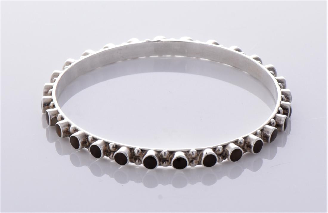 Tiger eye studded sterling silver bracelet. Estima: Tiger eye studded sterling silver bracelet. Estimated more than 50 yrs. old. 925 Sterling Silver consisting of 92.5% silver and 7.5% copper. Tested Positive using Nitric Acid Chemical Scratch Test, Cl