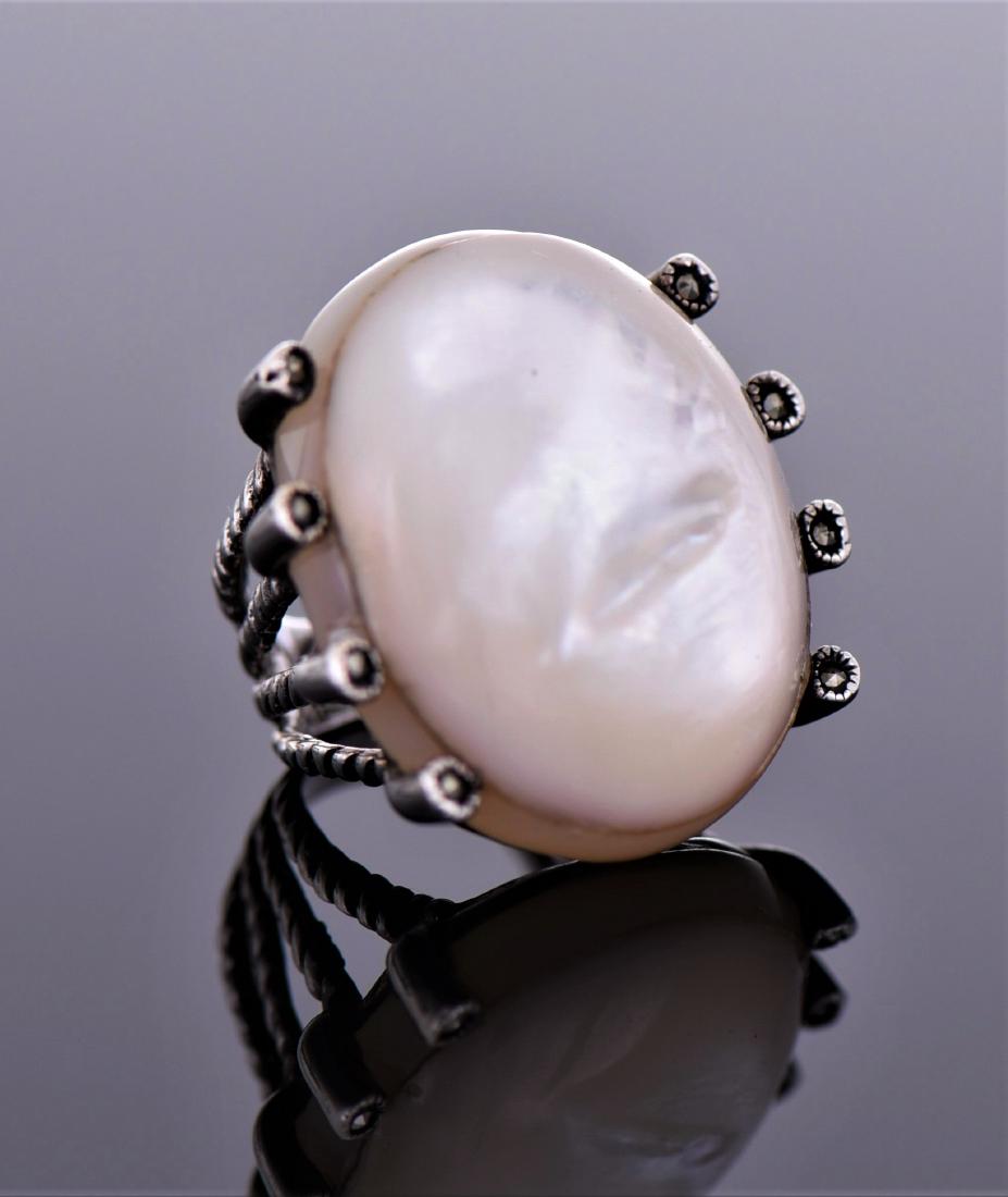 Large Mother of Pearl And Marcasite Sterling: Large Mother of Pearl And Marcasite Sterling Silver Ring. Signed Pk, 925. Ring Size Shown On Last Photo. Estimated more than 50 yrs old. 925 Sterling Silver consisting of 92.5% silver and 7.5% copper.