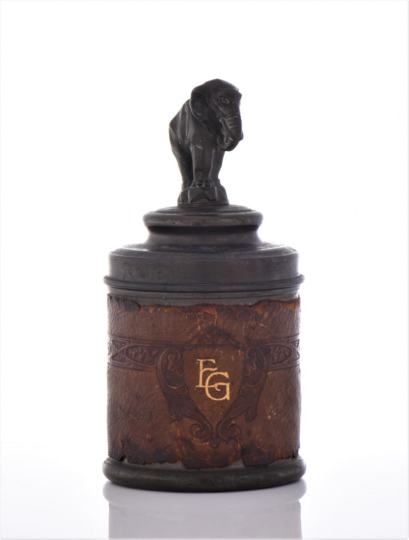 Cigarette Tin Caddy With An Art Deco Elephant: Cigarette Tin Caddy With An Art Deco Elephant Topper, Lined with Leather and Marked With FG initials. Estimated more than 75 yrs old. Art Deco is a style of visual arts, architecture and design that f