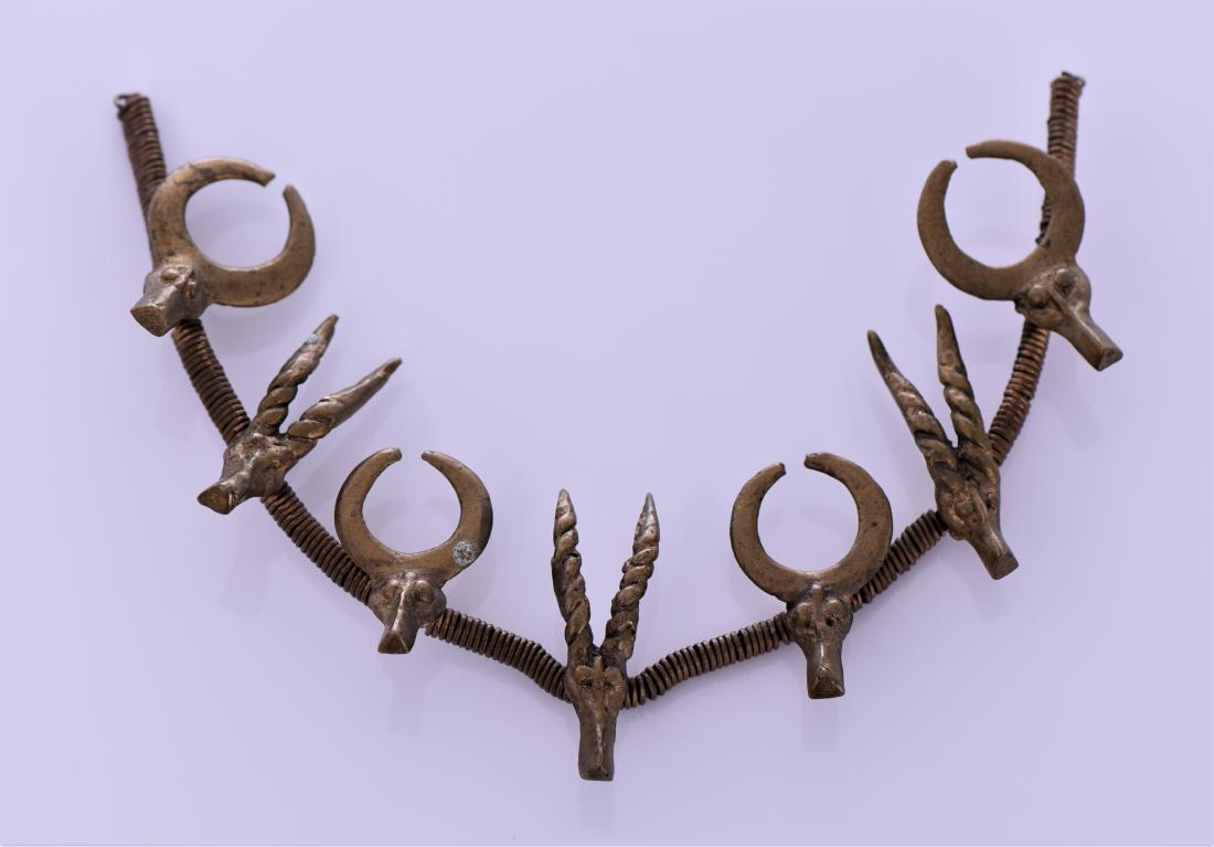 Antique Burmese Wired Brass Tribal Necklace: Antique Burmese Wired Brass Tribal Necklace With Bull And Gazelle Heads. Estimated more than 100 yrs old.Southeast Asia is a subregion of Asia, consisting of the countries that are geographically sout