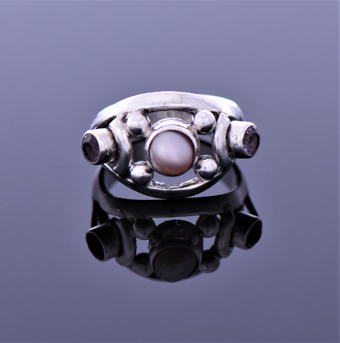 Vintage Pearl And Amethyst Sterling Silver: Vintage Pearl And Amethyst Sterling Silver Ring. Ring Size 8. Estimated more than 50 yrs old. 925 Sterling Silver consisting of 92.5% silver and 7.5% copper. Tested Positive using Nitric Acid Chemical