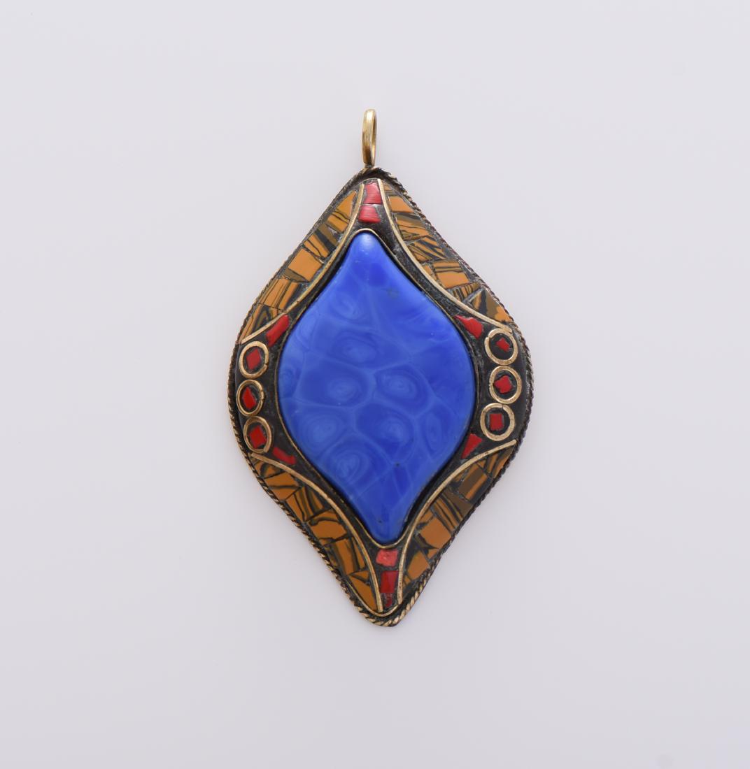 Medallion Brass Pendant With Blue Malachite: Medallion Brass Pendant With Blue Malachite, Red Coral And Tiger Eye Stone Inlay. Estimated more than 75 yrs old. Tibetan artists have played a key role in the cultural life of Tibet for more than a t