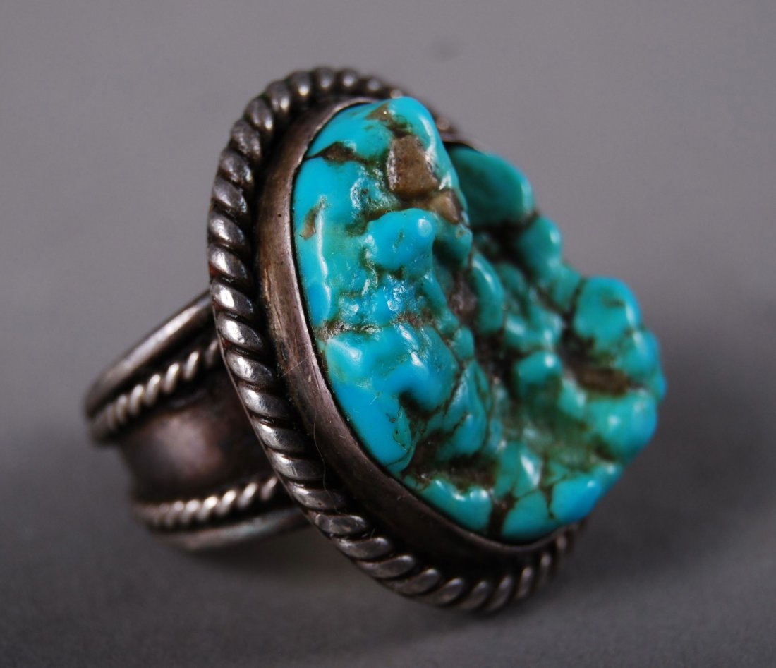 Turquoise Sterling Silver Ring with Roping: Turquoise Sterling Silver Ring with Roping [Height/Length (in)= 1.25, Width (in)=1.25, Depth (in)=1.25, Weight (lbs)=0.75] With C.O.A. signed by Chief Joe Dan Osceola & Seminole Tribe.