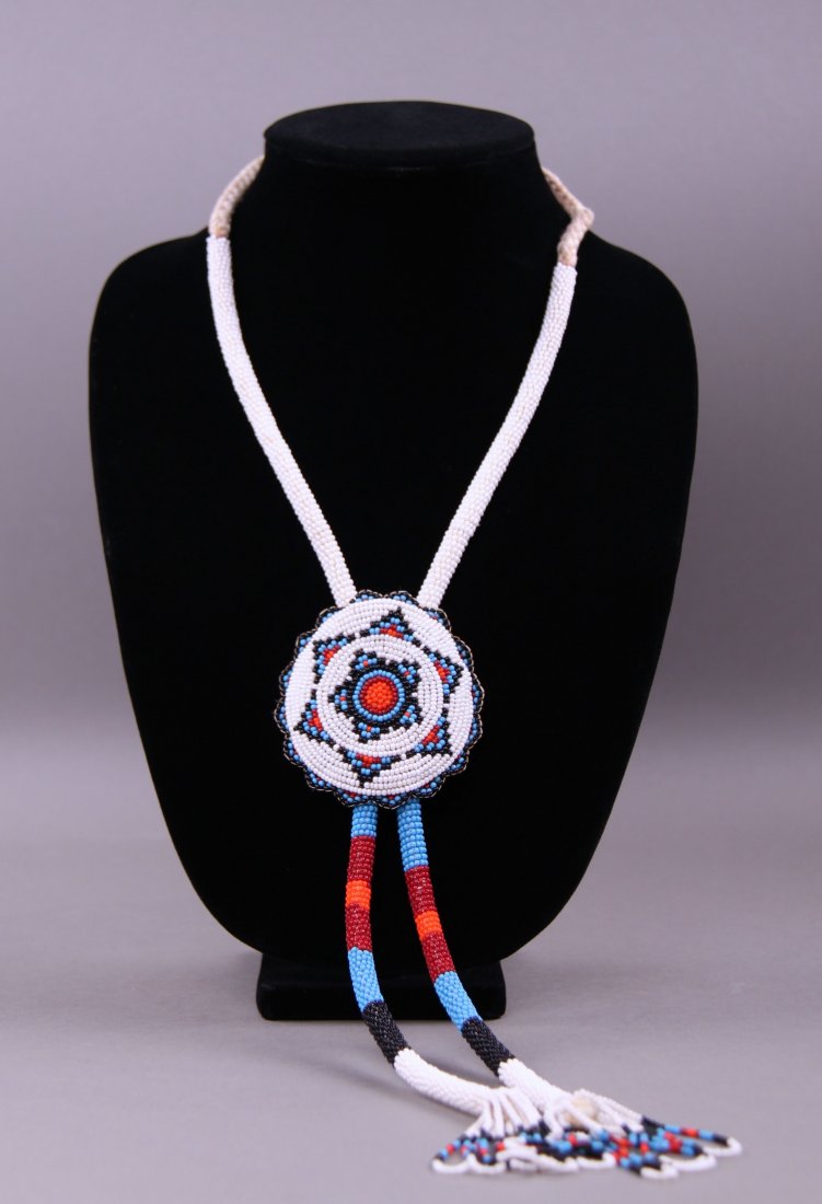 20th Century Hand Beaded Bola tie. Native American: 20th Century Hand Beaded Bola tie. Native American Zuni tribe.(Size: See last photo for measurement.) Photos are part of the description representing the condition report. Pangaea Auctions urges Bidde