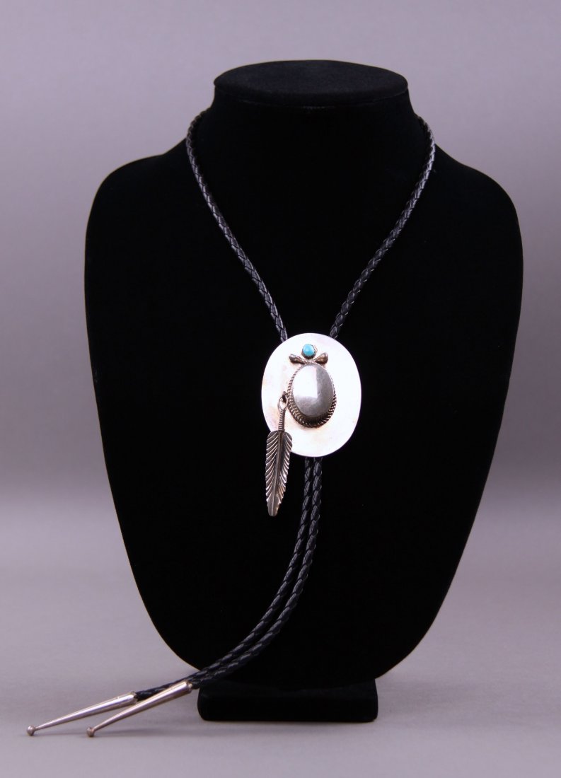 Zuni Native American Bola tie with silver and hat and: Zuni Native American Bola tie with silver and hat and feather with a turquoise stone.(Size: See last photo for measurement.) Photos are part of the description representing the condition report. Panga