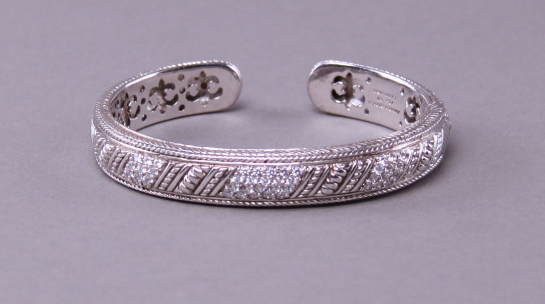 Sterling silver and Cubic Zirc+B119onia bangle from: Sterling silver and Cubic Zirc+B119onia bangle from Thailand. 47.5g. Stamped Judith Ripca 925 CZ Thailand.(Size: See last photo for measurement.) Photos are part of the description representing the co