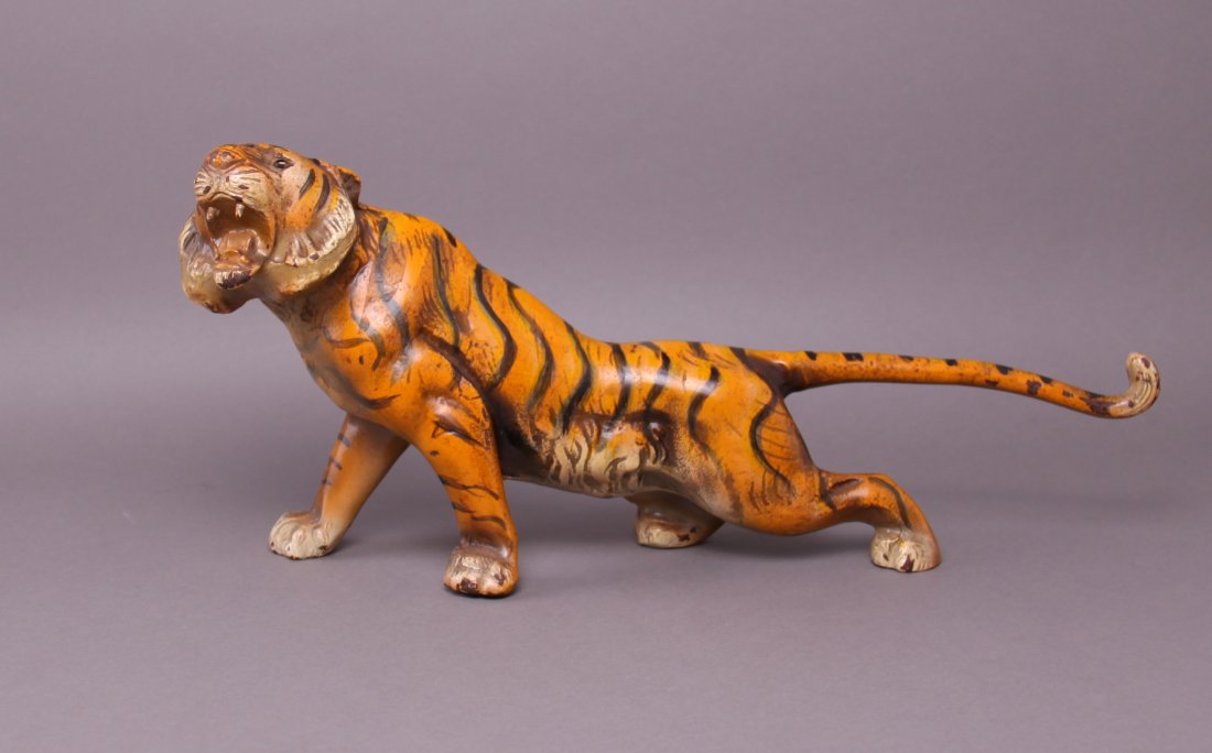 Rare 19th Century Iron Tiger Doorstop with glass eyes.: Rare 19th Century Iron Tiger Doorstop with glass eyes. This is one of the doorstops created for "The Jungle Boy" story. It is meant to sit next to the other doorstop of the Jungle Boy hugging the tige