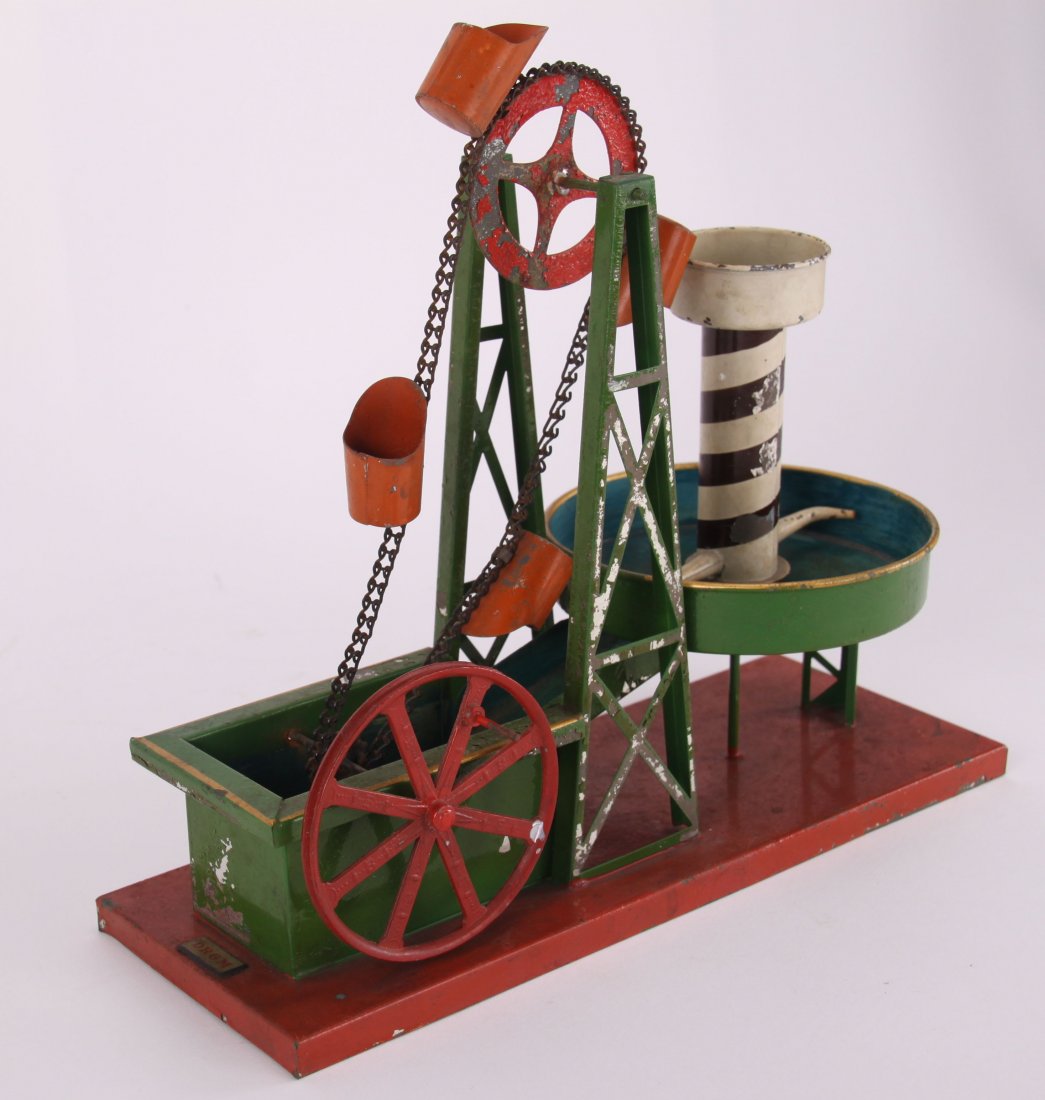 DRGM, German made tin toy, of a spinning water mill.: DRGM, German made tin toy, of a spinning water mill. (Size: See second photo for measurement.) Photos are part of the description representing the condition report. Pangaea Auctions urges Bidder's to 