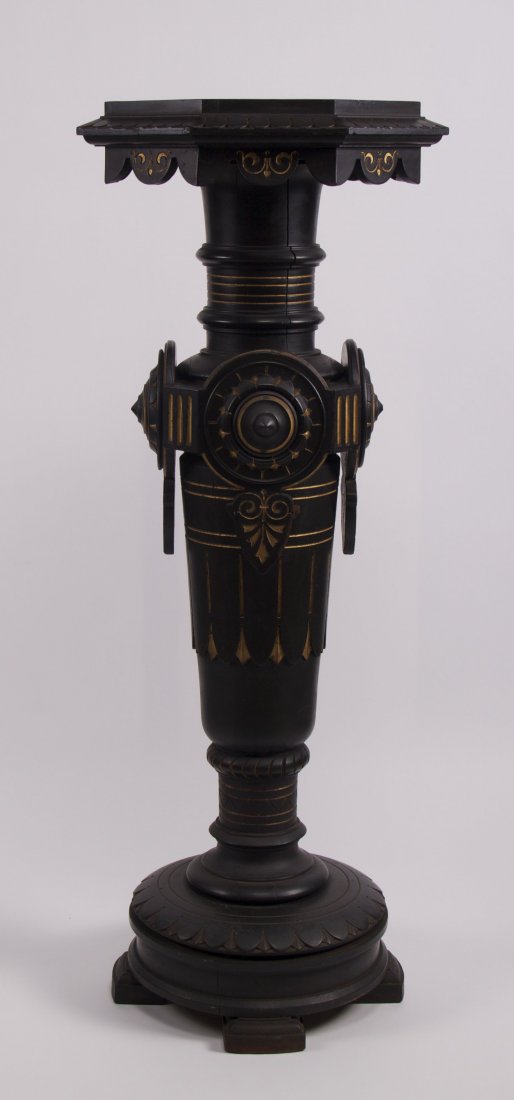 Antique Victorian display pedestal. Carved wood with: Antique Victorian display pedestal. Carved wood with ebonized finish, incised carving and gilded detail. Condition Report: missing small under hang skirt section at the top. (Size: See second photo fo