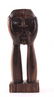 Jamaican wood carving depicting society putting on a