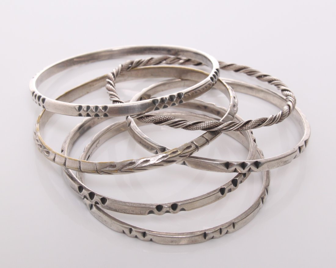 Five(5) Sterling silver bangles. Four made by Frantz H: Five(5) Sterling silver bangles. Four made by Frantz Hingelberg and one from Mexico. Markings: F. Hingelberg, Denmark. Frantz Hingelberg began the production of independent, artistically designed jewe
