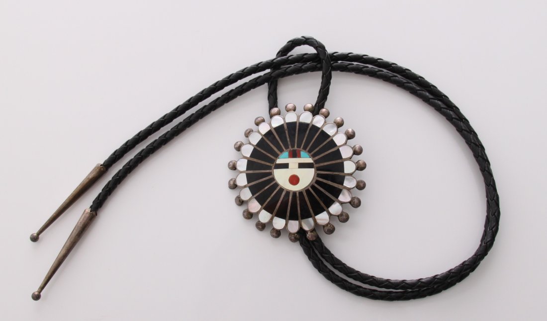 Zuni Native American Bola tie made with silver, inlaid: Zuni Native American Bola tie made with silver, inlaid turquoise and other precious stones. Circular starburst design. SIZE: see attached ruler photo. Photos are part of the description representing t