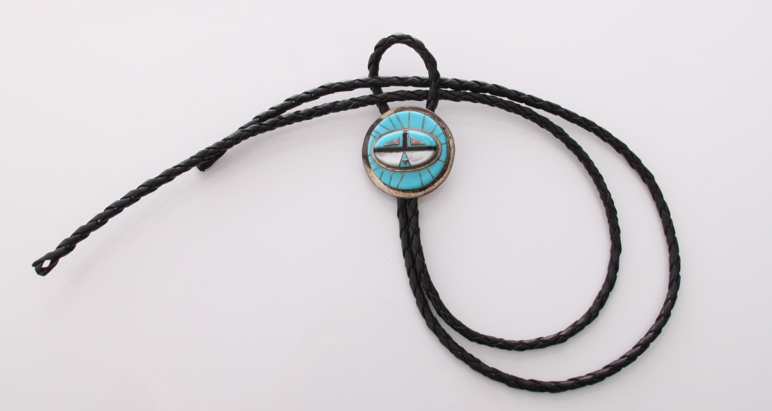 Zuni Native American Bola tie with silver and inlaid tu: Zuni Native American Bola tie with silver and inlaid turquoise, mother of pearl, coral, and other precious stones. Circular design, signed RWAJ. SIZE: see attached ruler photo. Photos are part of the 