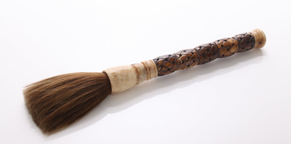 Vintage Asian bone calligraphy brush. Calligraphy is a: Vintage Asian bone calligraphy brush. Calligraphy is a visual art related to writing. It is the design and execution of lettering with a broad tip instrument, dip pen, or brush, among other writing in