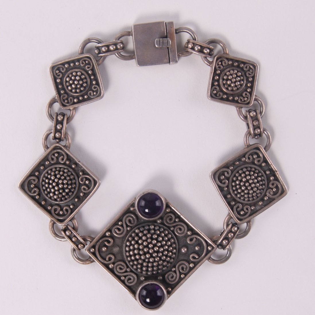 Indonesian sterling silver bracelet with purple stones,: Indonesian sterling silver bracelet with purple stones, marked "925 BA." SIZE: see attached ruler photo. Photos are part of the description representing the condition report and can be used for authen