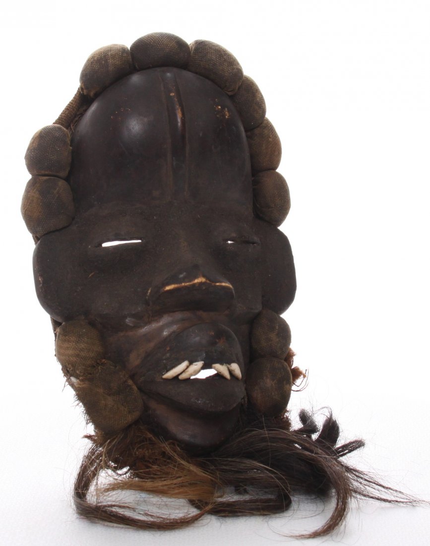 African Dan Complex tribal mask from Liberia a: African Dan Complex tribal mask from Liberia and Cote D'Ivoire, ceremonial dance mask, or runner's mask, 19th Century. Real human hair and shells for teeth. Masks among the Dan people functioned on ma
