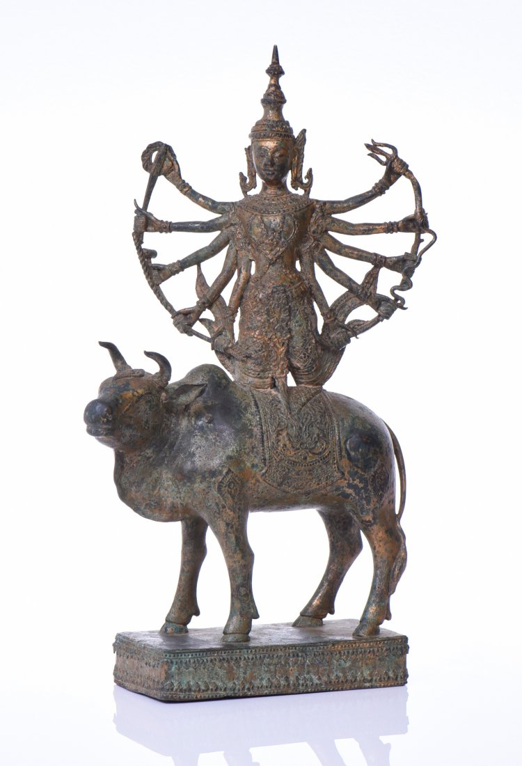 Gold Gilt Bronze Buddha. The Ten Armed Buddha: Gold Gilt Bronze Buddha. The Ten Armed Buddha Is Kneeling Upon The Back Of A Sacred Cow On A Bronze Base. Estimated more than 100 yrs old. Indian art consists of a variety of forms, including pottery,