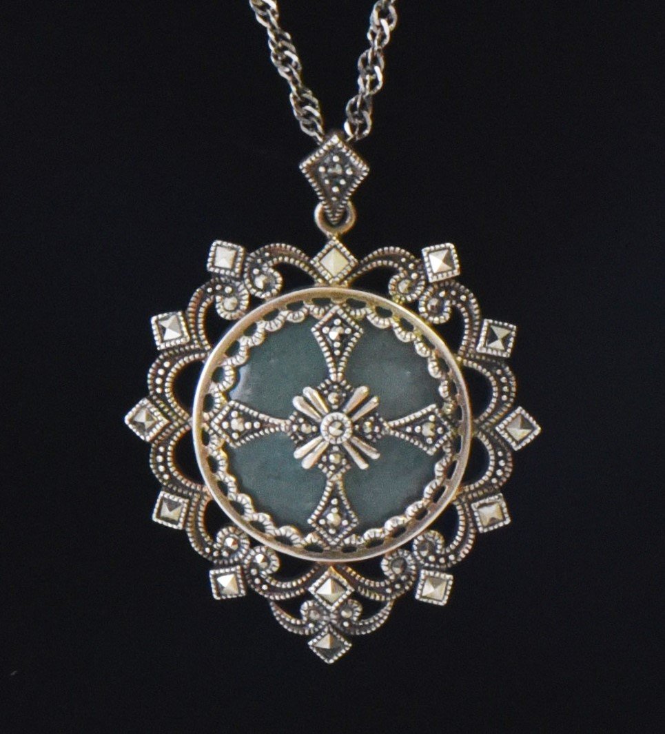 Jade Sterling Silver Pendant with Marcasite St: Jade Sterling Silver Pendant with Marcasite Stones. Base Stand Not Included. Estimated more than 50 yrs old. Jadeite is called Yingyu in Chinese, with a Mohs hardness of 7; its pressure bearing capaci